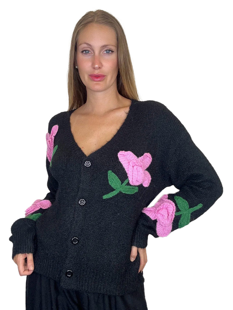 Women's wholesale love appliqué knit top featuring textured lettering and a playful sequin flower detail
