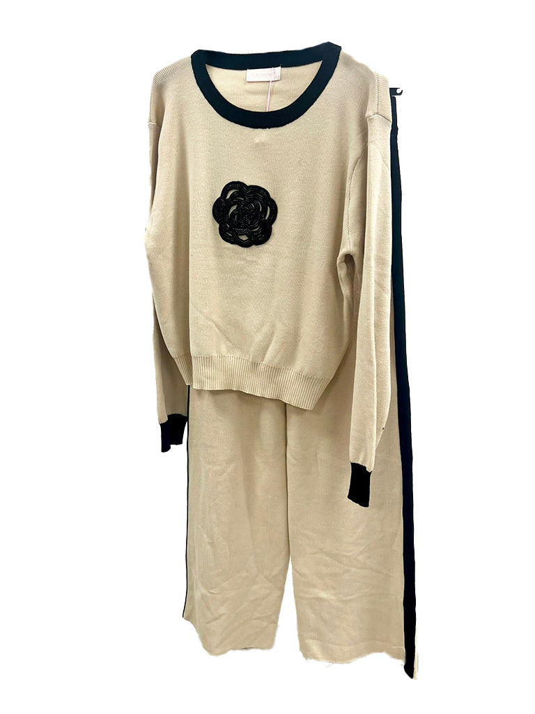 Women's knit jumper and wide leg trouser coord set with applique flower detail, featuring an elasticated waist