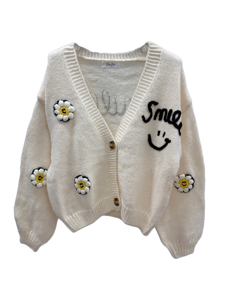 Women's wholesale smile cardigan with 'smile everyday' weave and daisy appliqués