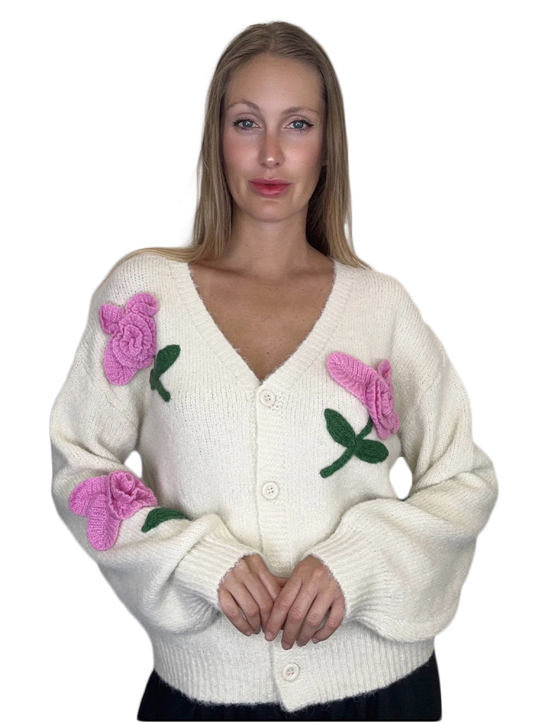 Women's wholesale love appliqué knit top featuring textured lettering and a playful sequin flower detail
