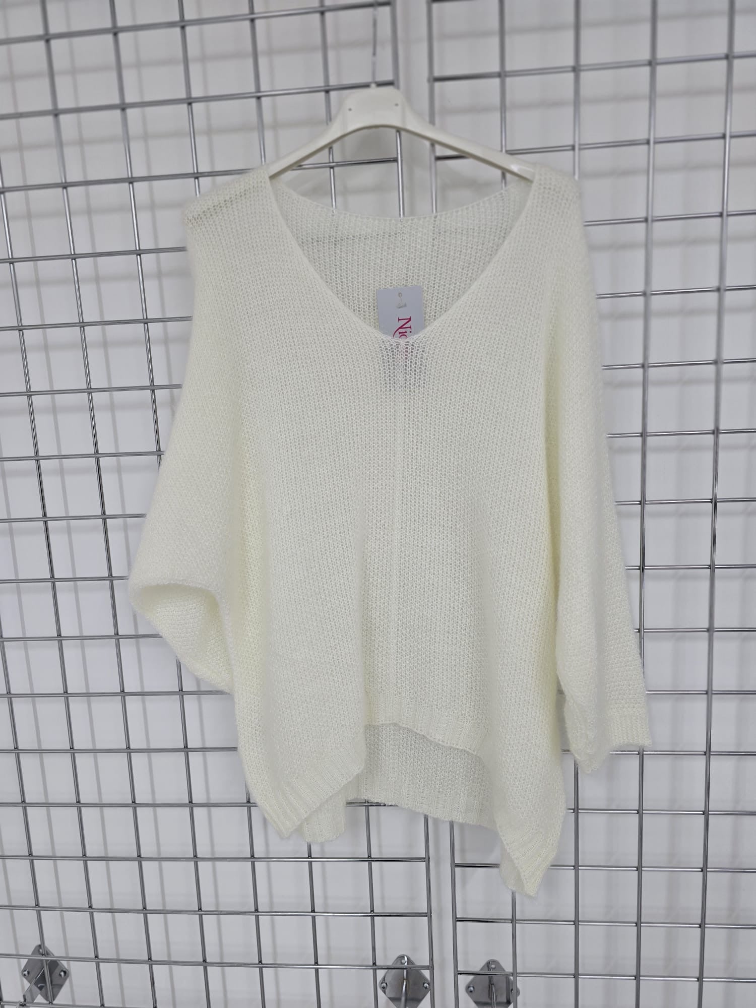 Women's wholesale oversized V neck sweater with a dipped hem, crafted from soft light-knit fabric