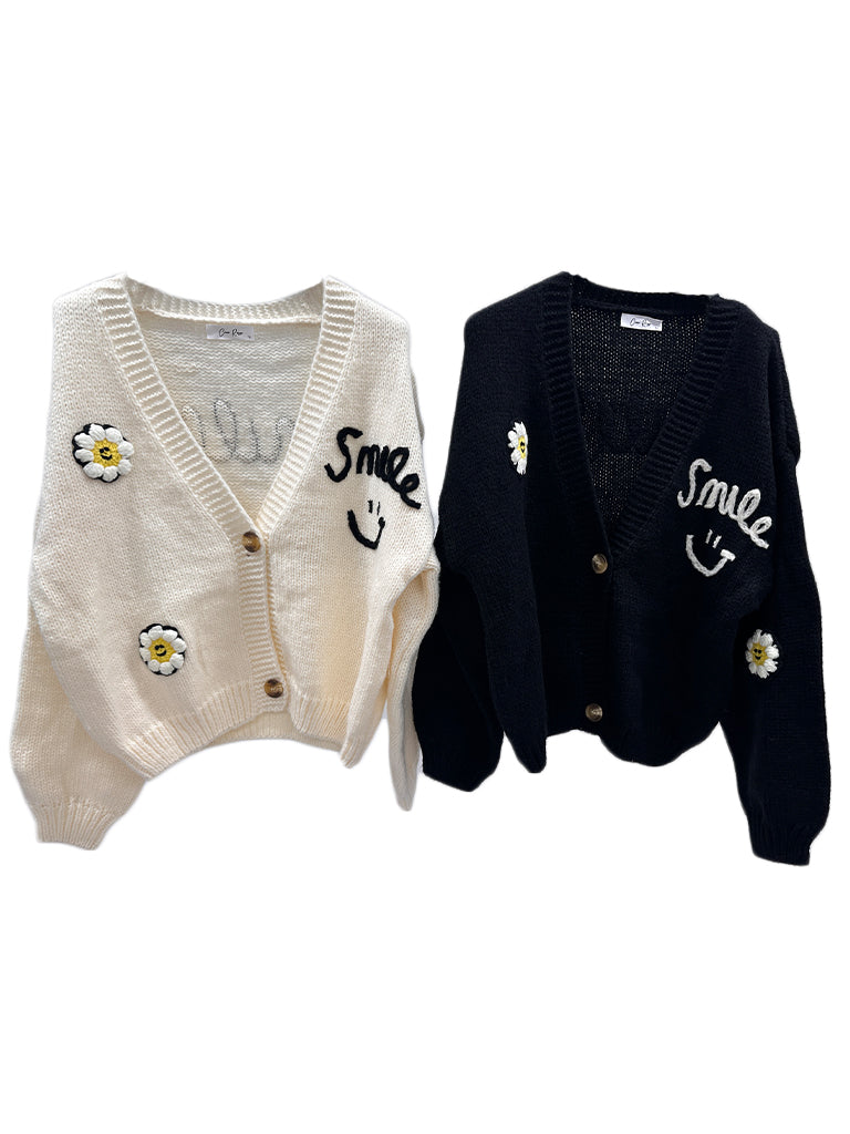Women's wholesale smile cardigan with 'smile everyday' weave and daisy appliqués