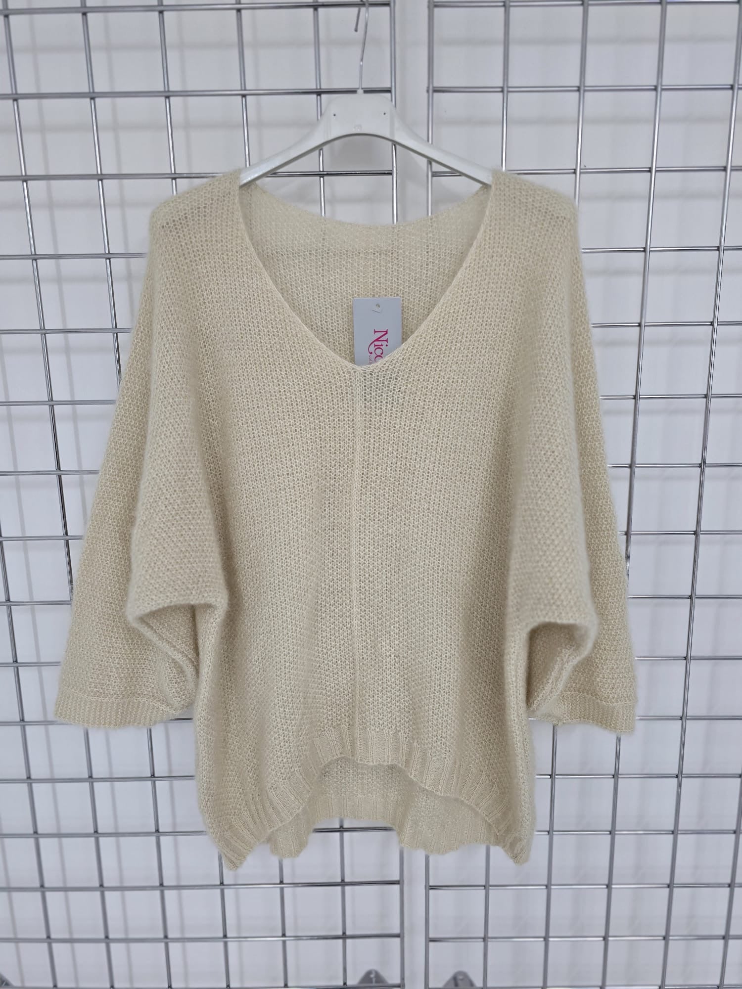 Women's wholesale oversized V neck sweater with a dipped hem, crafted from soft light-knit fabric