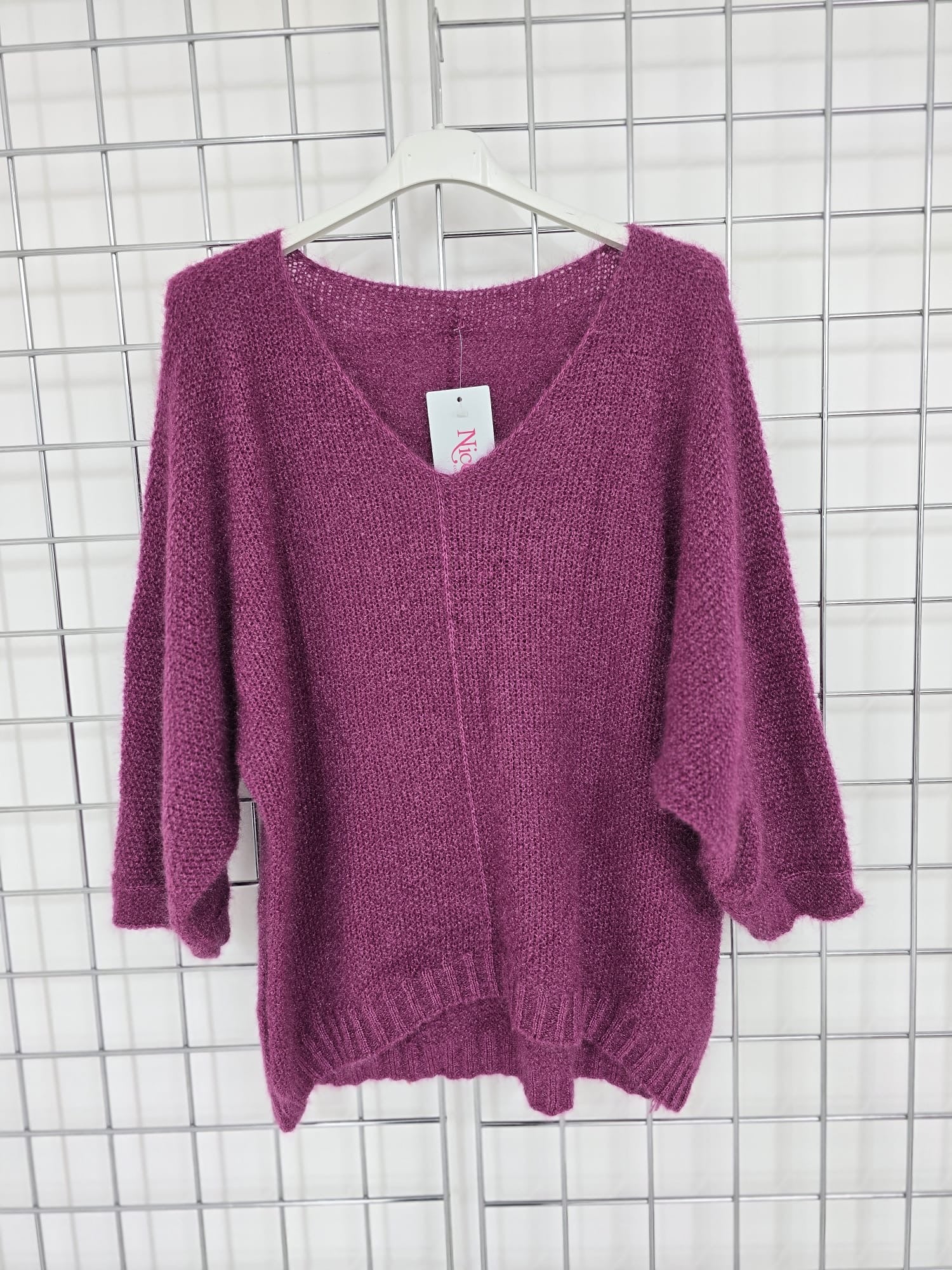 Women's wholesale oversized V neck sweater with a dipped hem, crafted from soft light-knit fabric
