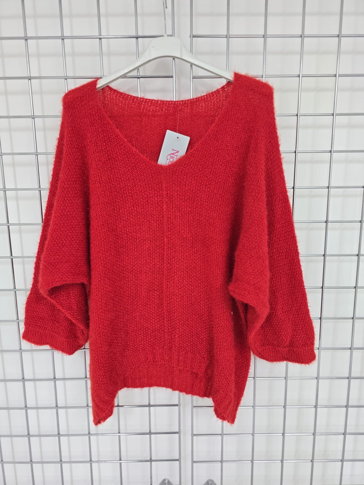 Women's wholesale oversized V neck sweater with a dipped hem, crafted from soft light-knit fabric