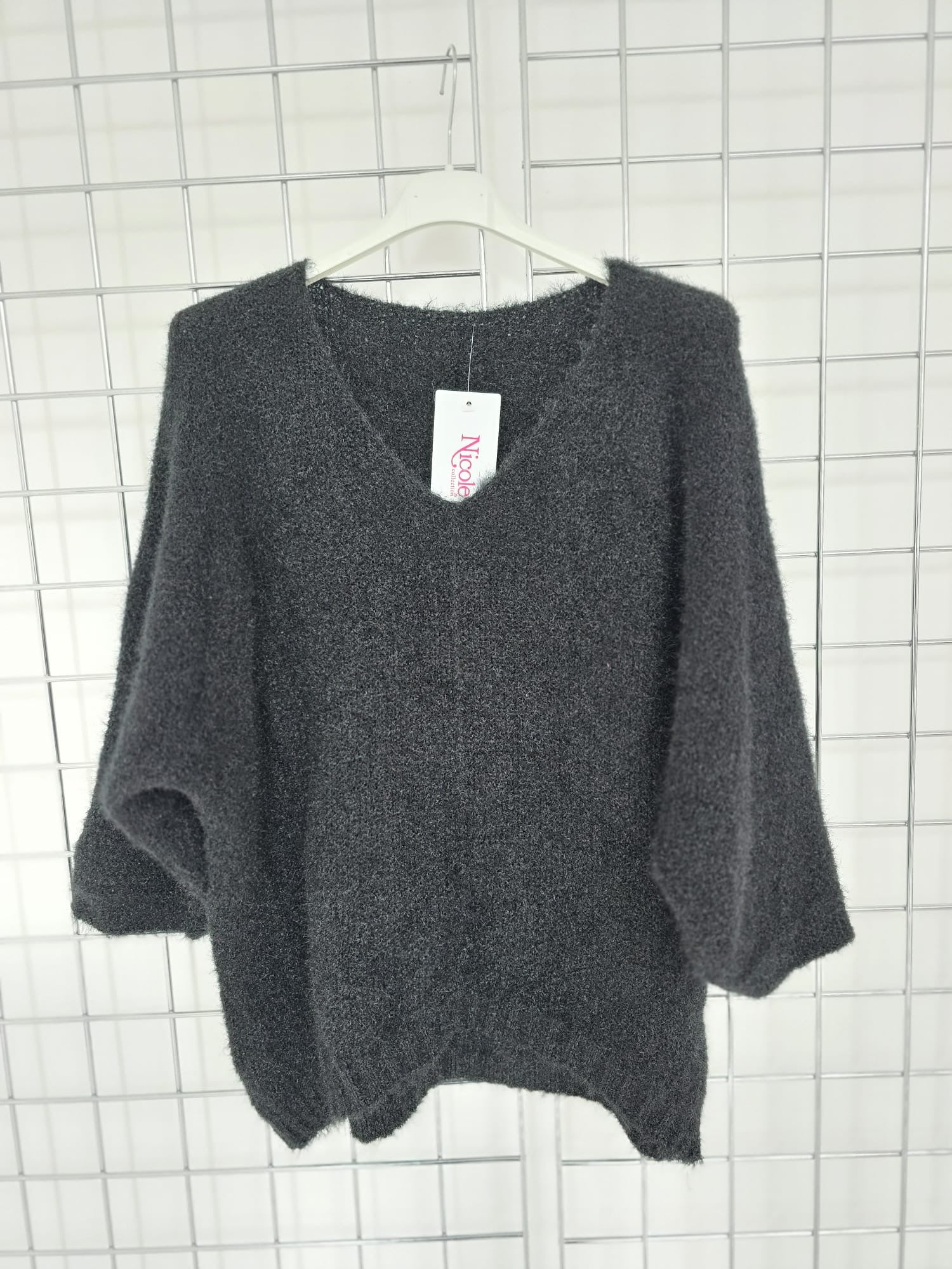Women's wholesale oversized V neck sweater with a dipped hem, crafted from soft light-knit fabric